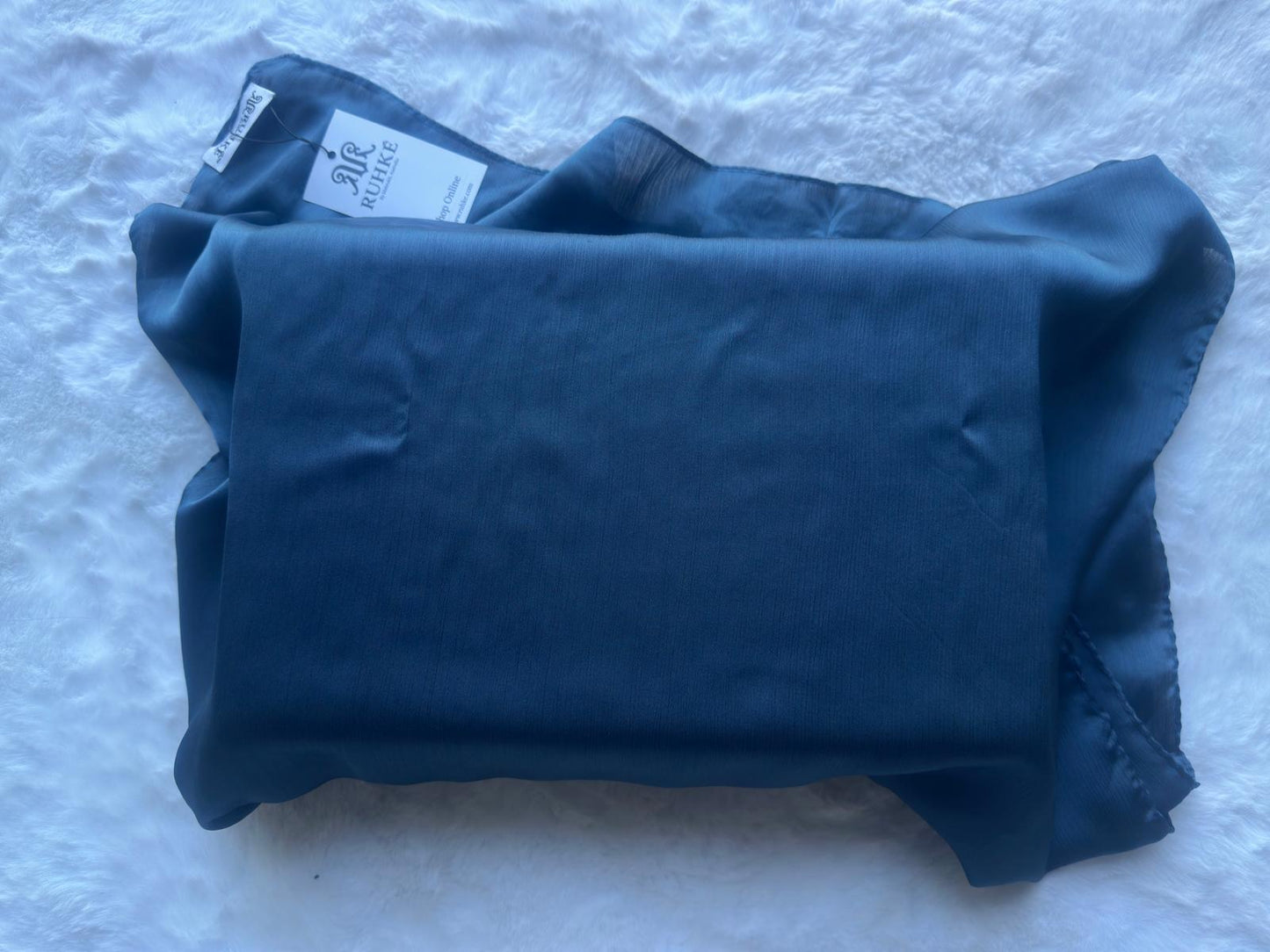 Steel blue satin crêpe Korean silk hijab laid flat, displaying full size and elegant satin sheen by RUHKÉ™