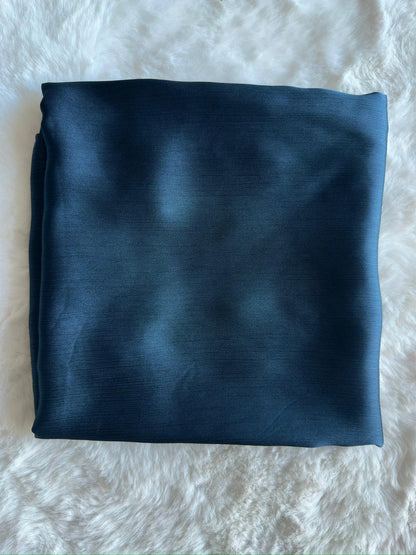 Steel blue satin crêpe Korean silk hijab folded neatly, showcasing premium fabric texture by RUHKÉ™