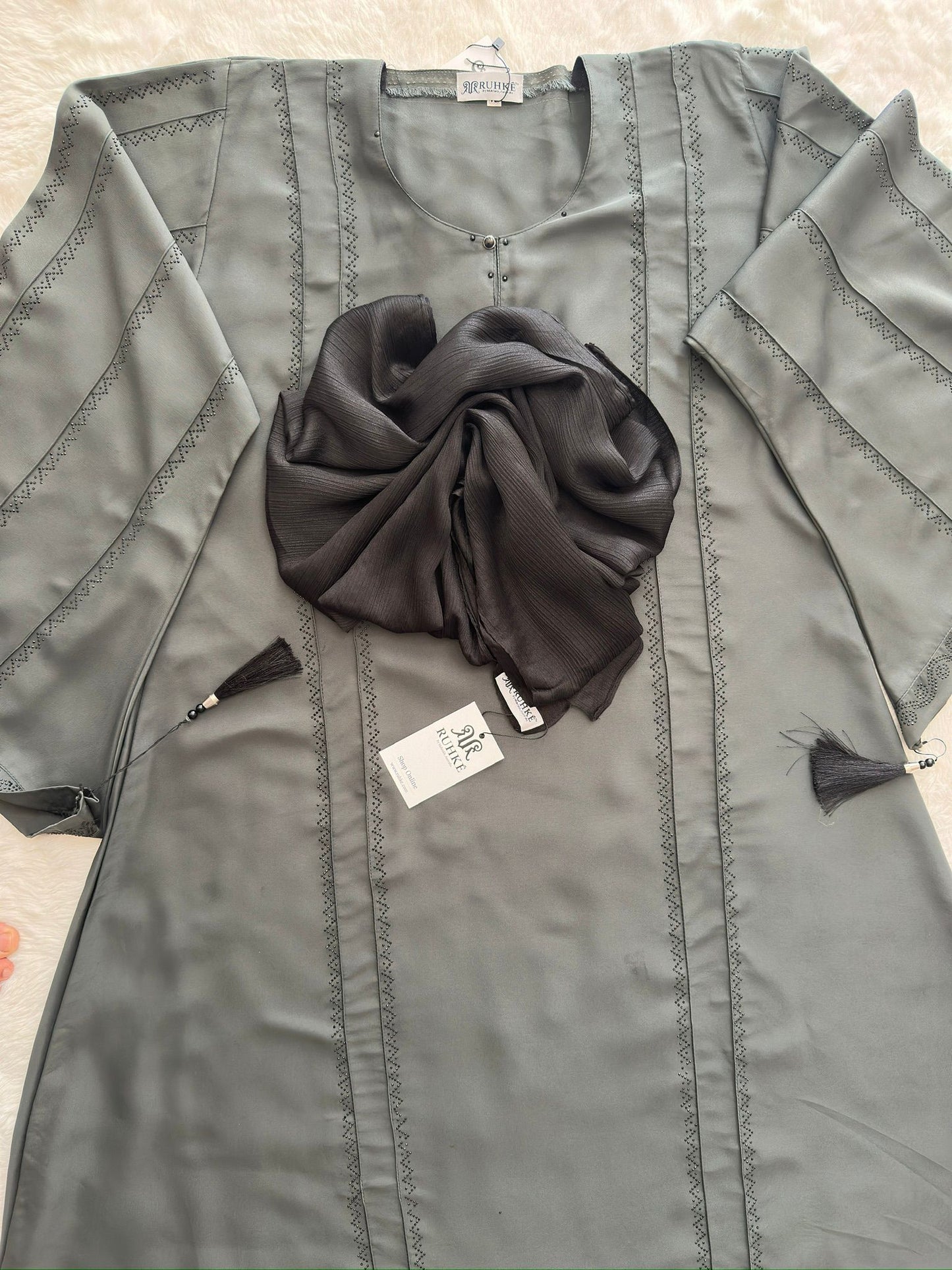 Close-up of stone embellishment on RUHKÉ olive grey luxury abaya