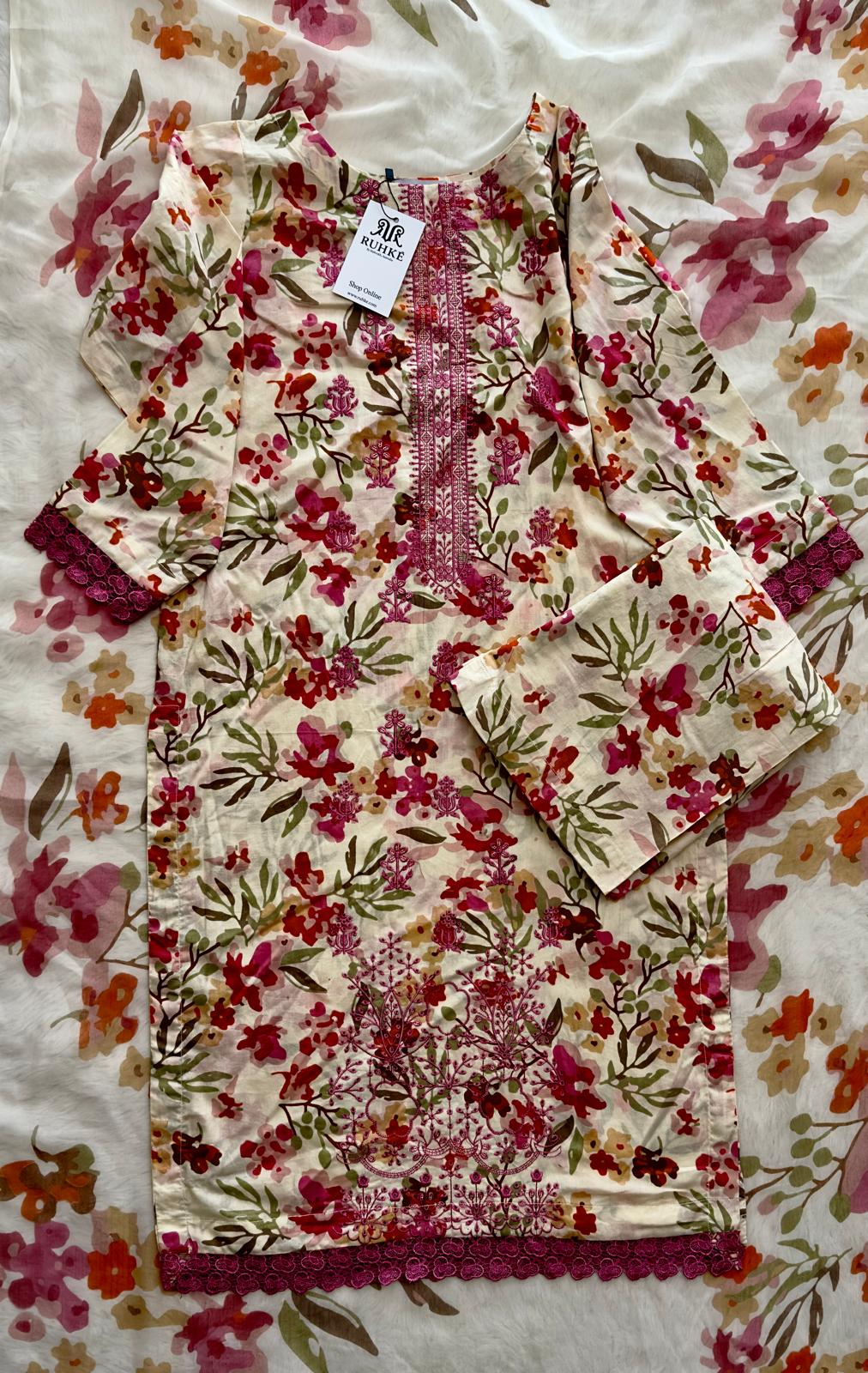 Close-up view of floral cream lawn suit fabric showing fine print detail, premium stitching, and soft breathable texture