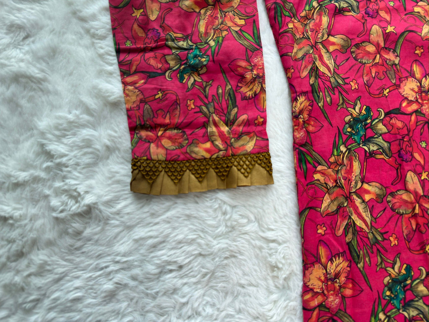 Close-up of contrast fabric lace patch on printed lawn dress sleeve