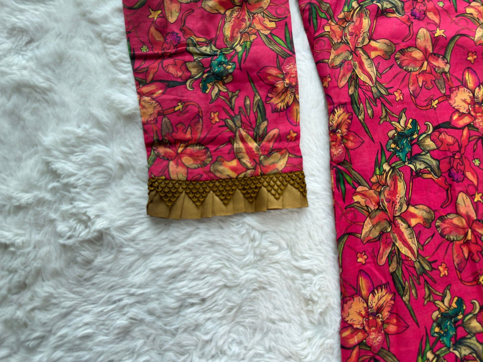 Close-up of contrast fabric lace patch on printed lawn dress sleeve