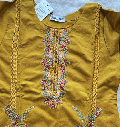 Yellow top with floral embroidery and a brand tag on a white background