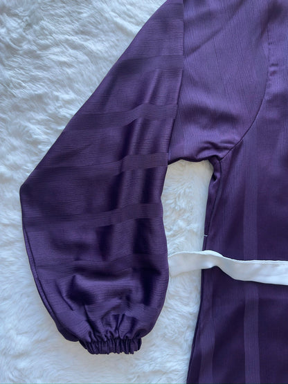Luxury modest abaya in deep plum textured silk with elegant flare and soft drape arm zoom
