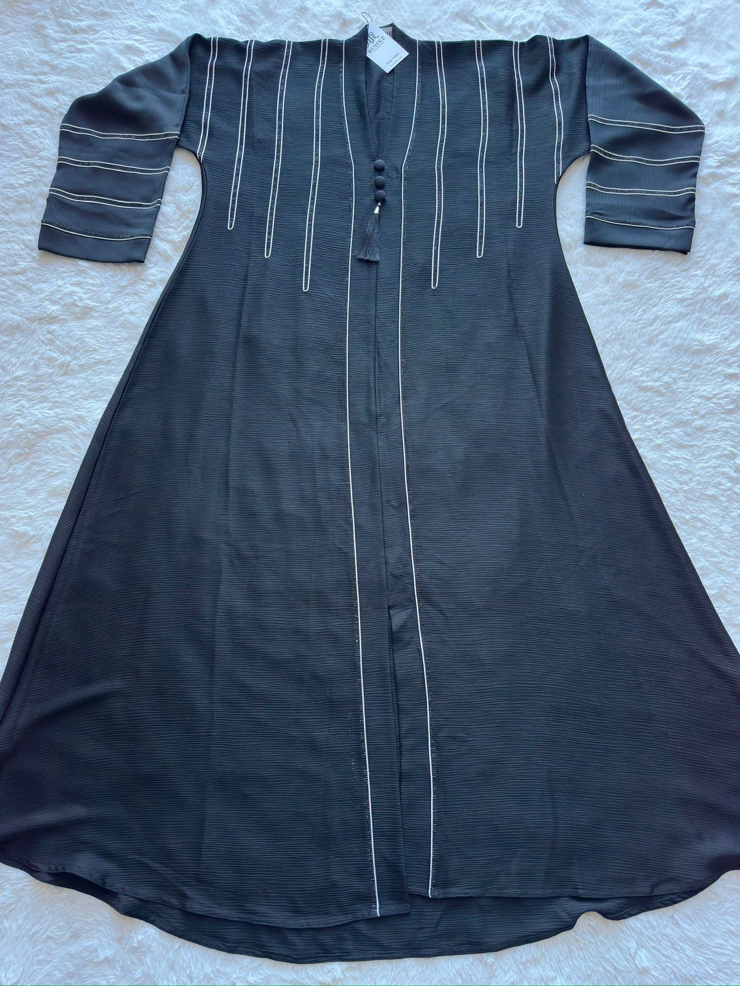 Designer black crêpe silk abaya featuring flared silhouette with handcrafted dori and stone detailing