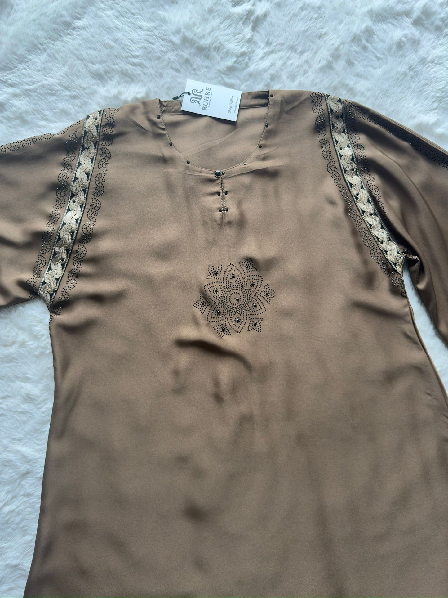 High-end black abaya with handcrafted gold embroidery and shimmering stone accents for formal occasions