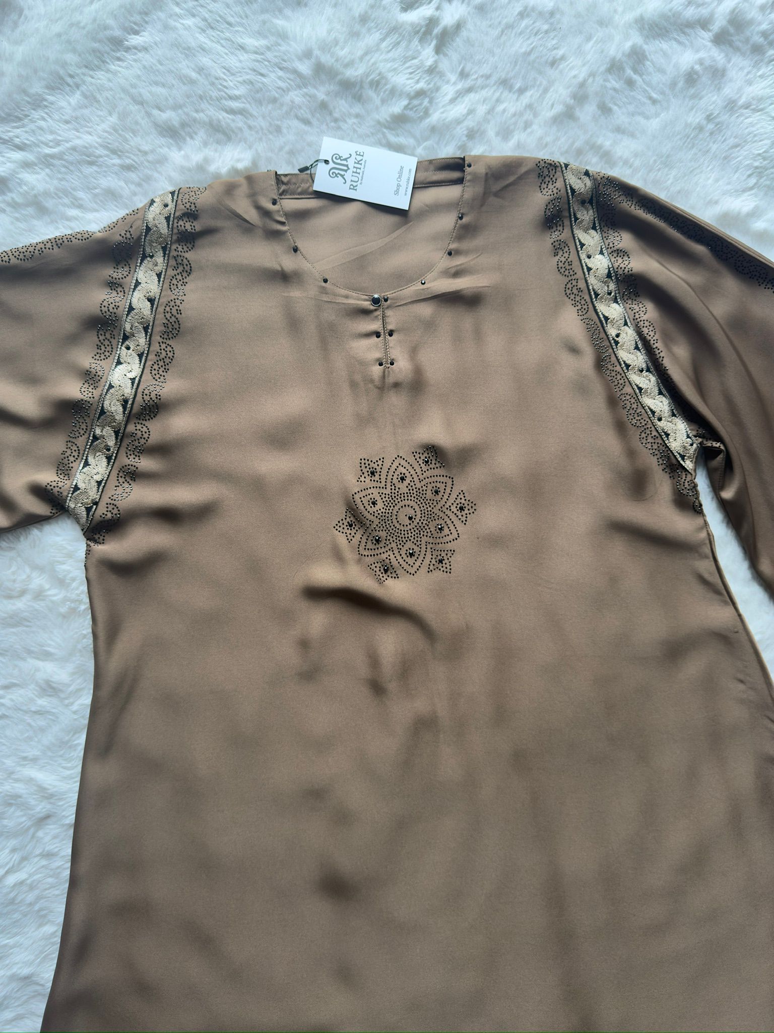 High-end black abaya with handcrafted gold embroidery and shimmering stone accents for formal occasions