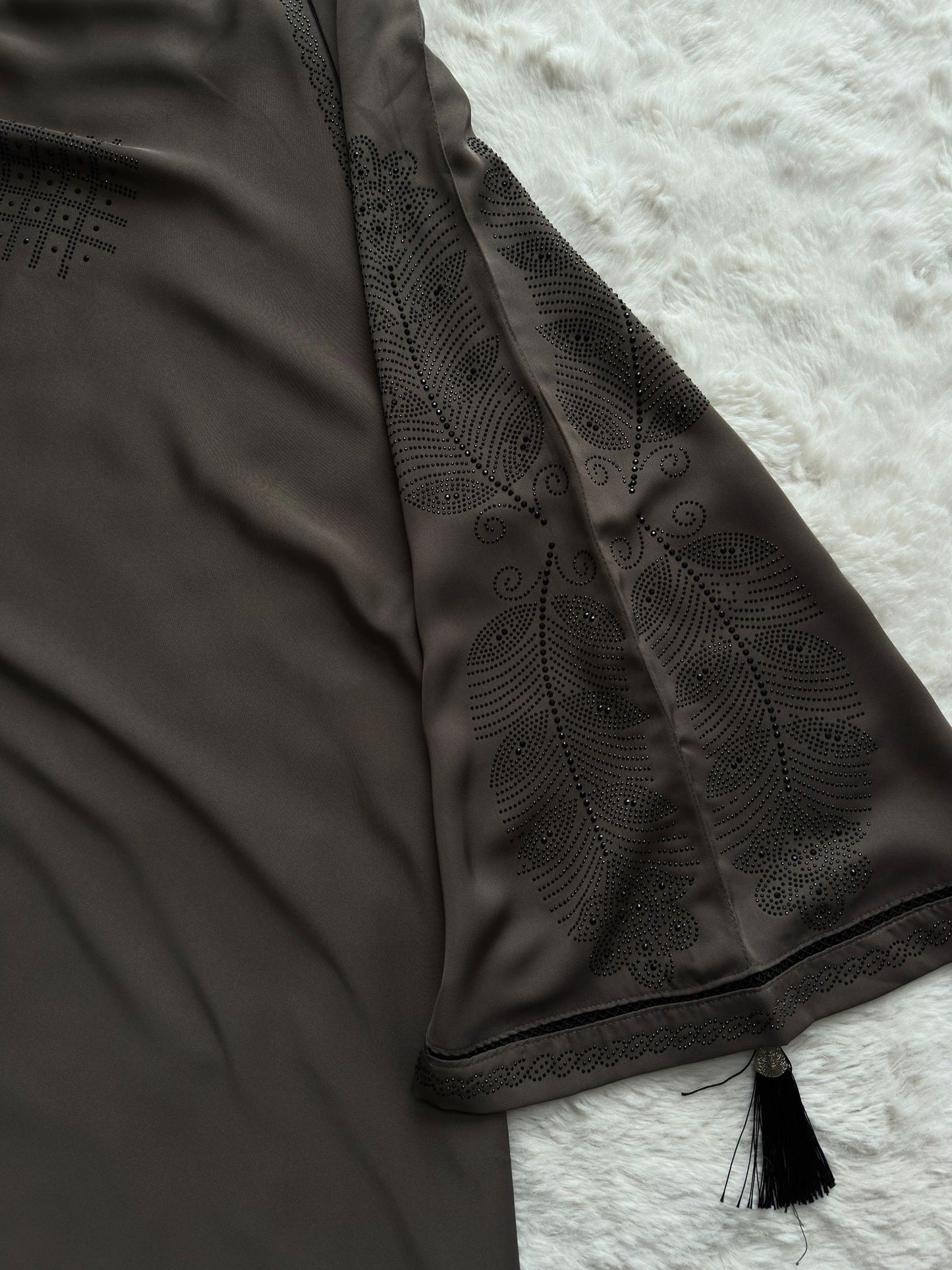 peacock work Close-up of embroidered cut-work sleeve detailing on luxury grey premium Nida abaya 