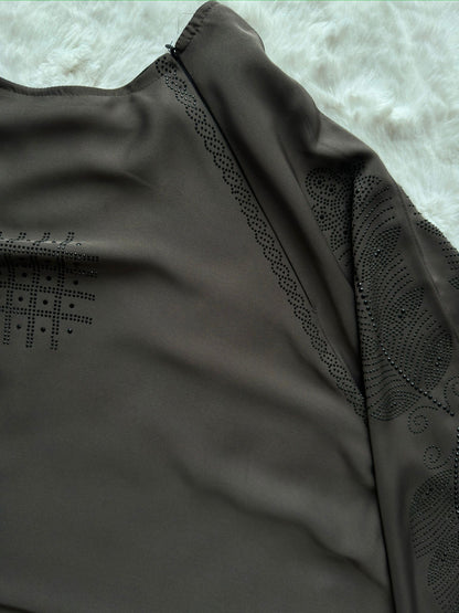 Close-up of embroidered cut-work sleeve detailing 