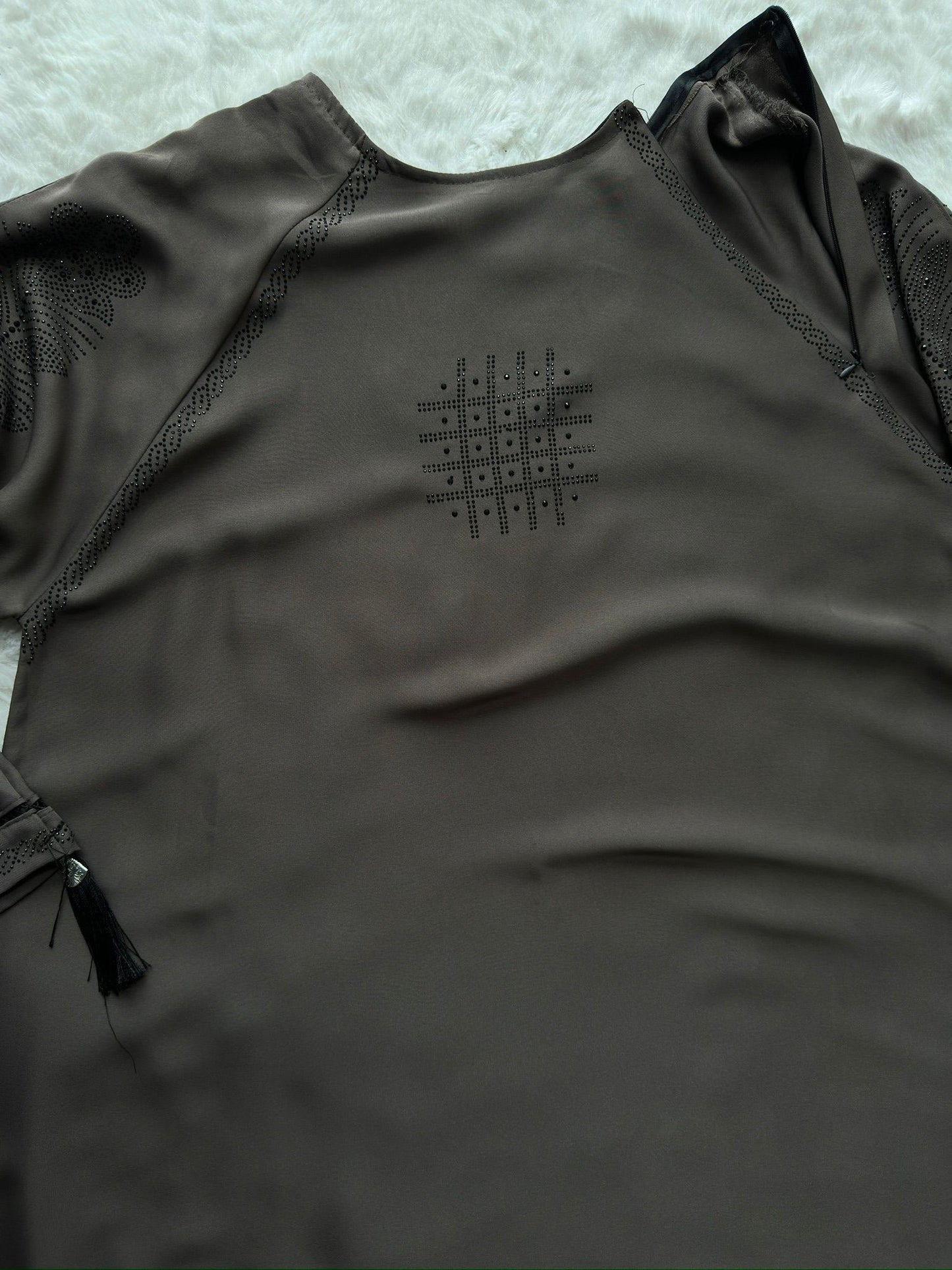 Close-up of embroidered cut-work sleeve detailing on luxury grey premium Nida abaya