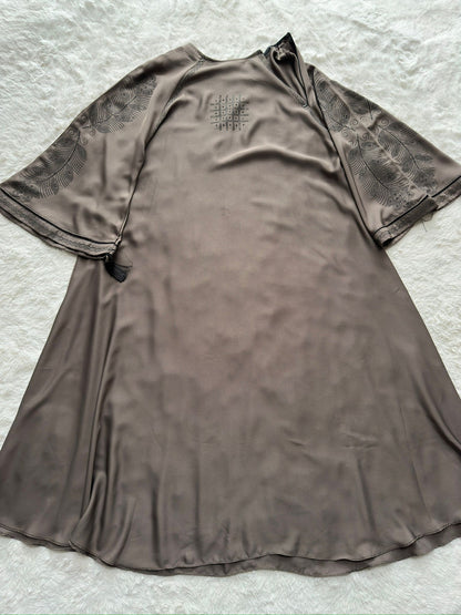 Front view of luxury grey Nida abaya with soft flowing flare, minimal chest detailing and embroidered cut-work sleeves
