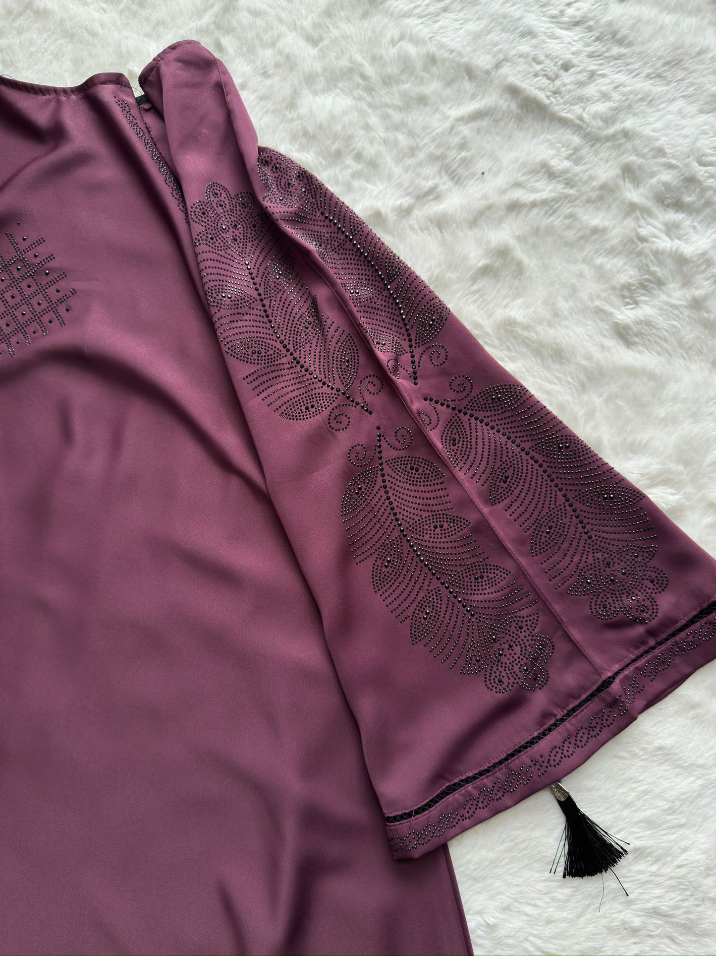 Close-up of plum premium Nida abaya showcasing refined stone and thread embroidery on sleeves peacock work