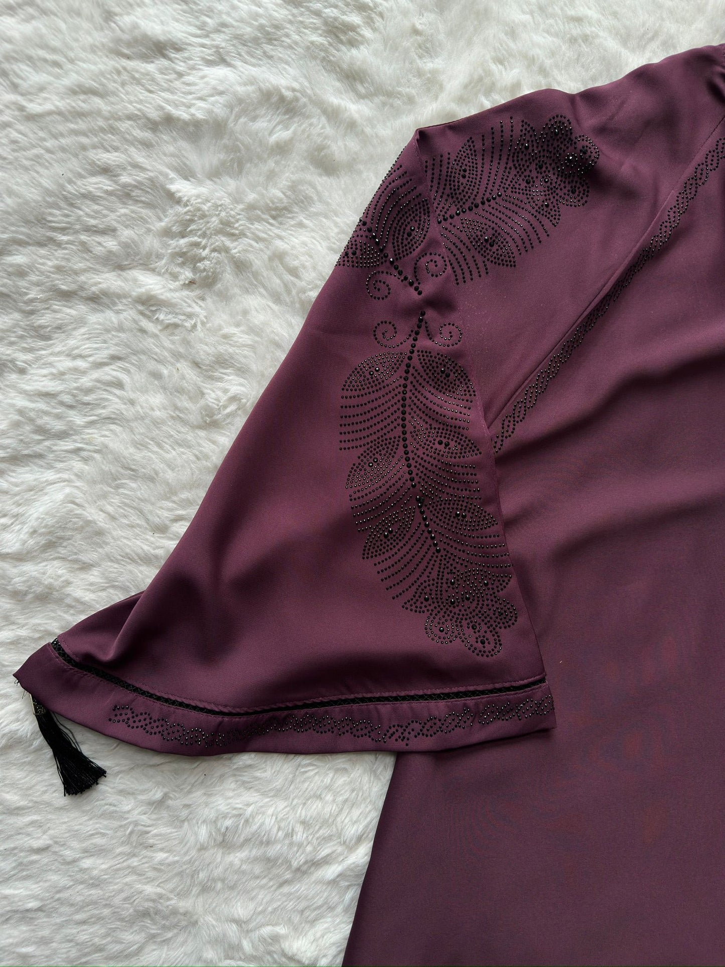 Close-up of plum premium Nida abaya showcasing refined stone and thread embroidery on sleeves