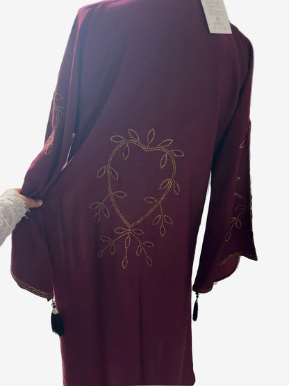 
Back view of luxury maroon Nida abaya with elegant reverse heart gold stone embroidery design