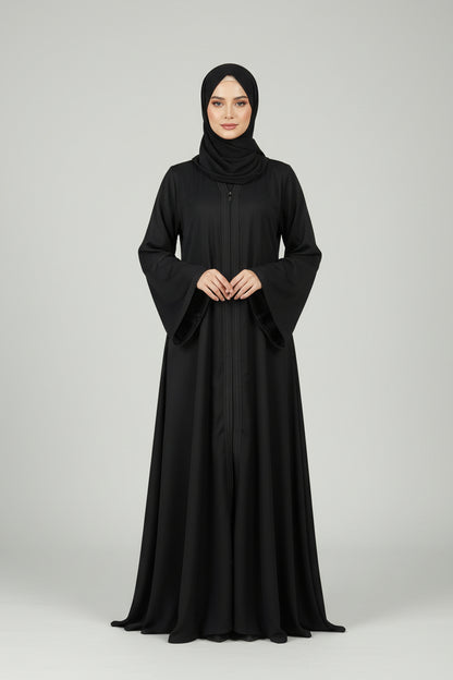 Black abaya worn by a model on a light gray background