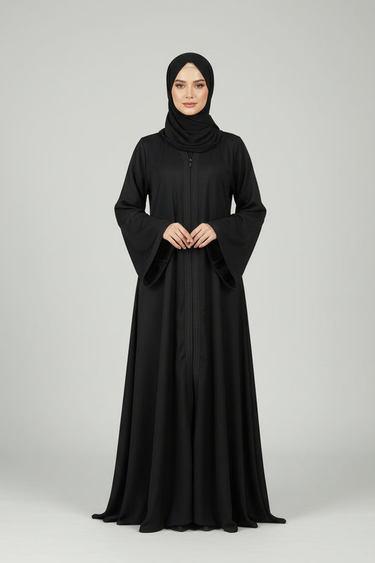 Black abaya worn by a model on a light gray background