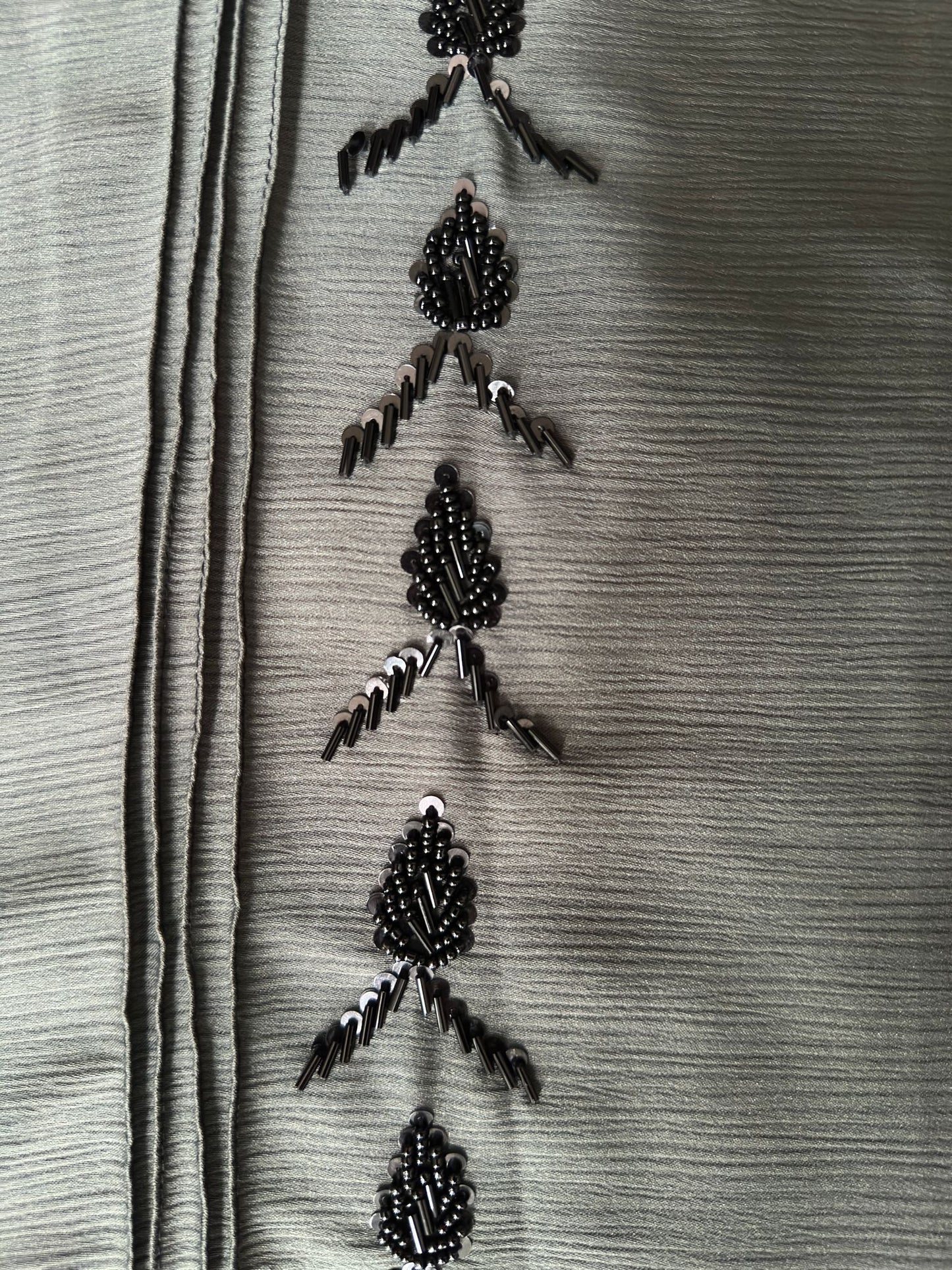 Full length sage green abaya with elegant black bead detailing