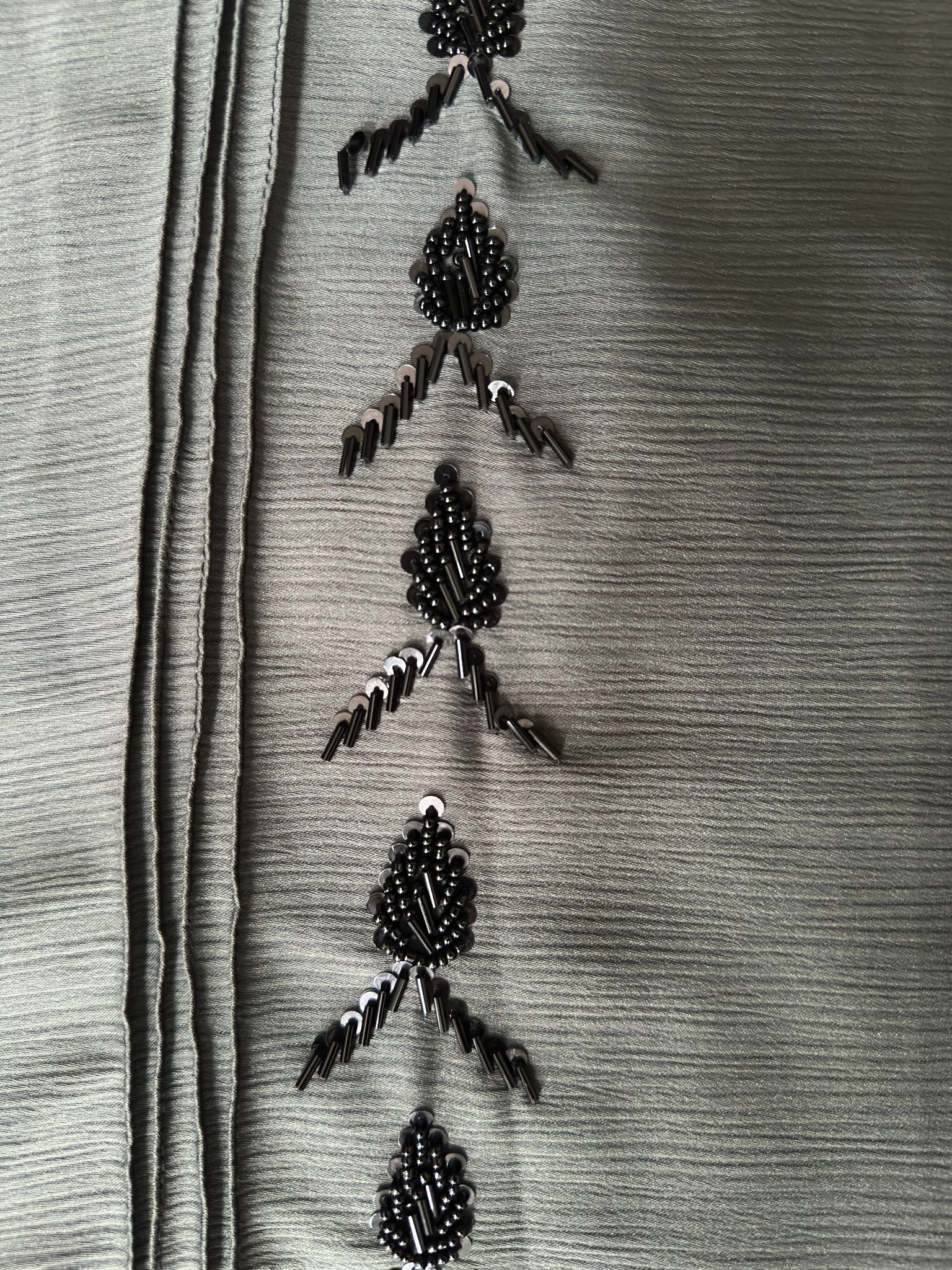 Full length sage green abaya with elegant black bead detailing