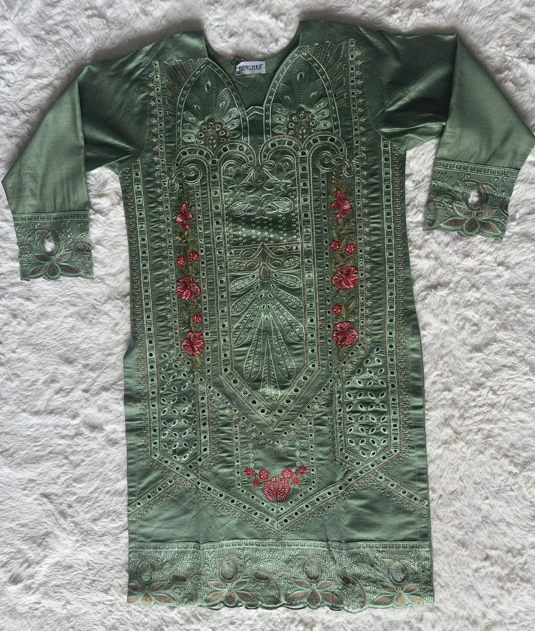 High-end sage green kurta set with detailed cut-work embroidery, delicate zari accents and luxury organza net dupatta by RUHKÉ