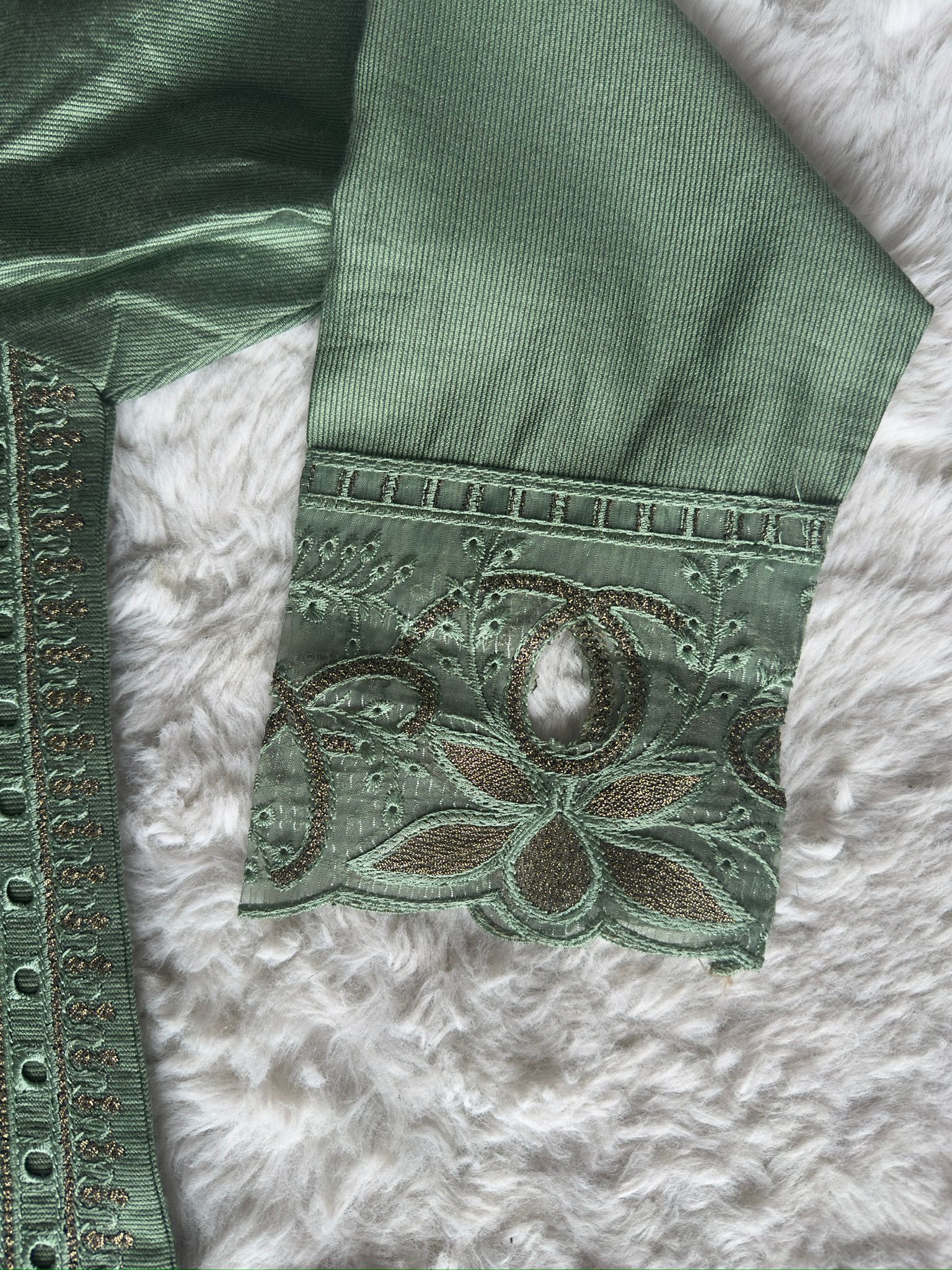 Elegant sage green luxury kurta showcasing intricate cut-work embroidery, zari highlights and a soft organza net dupatta by RUHKÉ