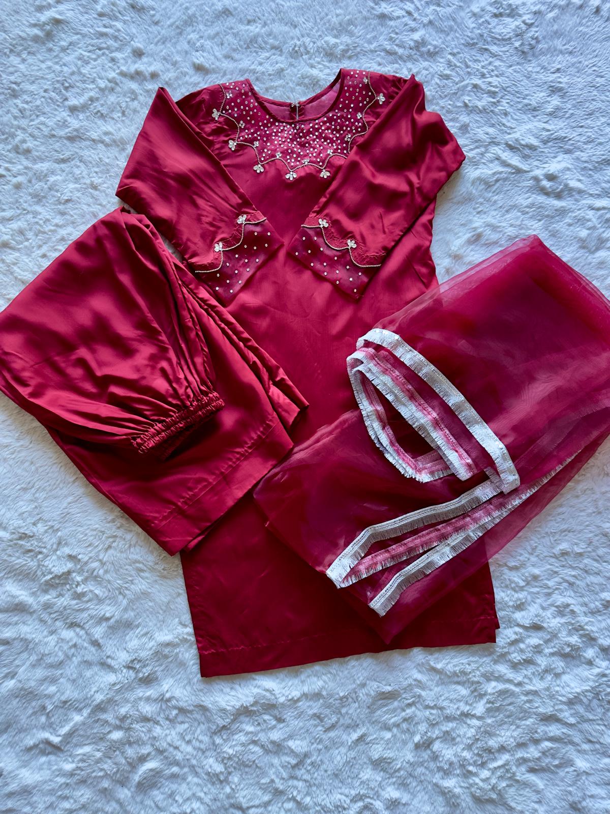 Close-up of handworked embroidery on red viscose silk long shirt with organza dupatta 
