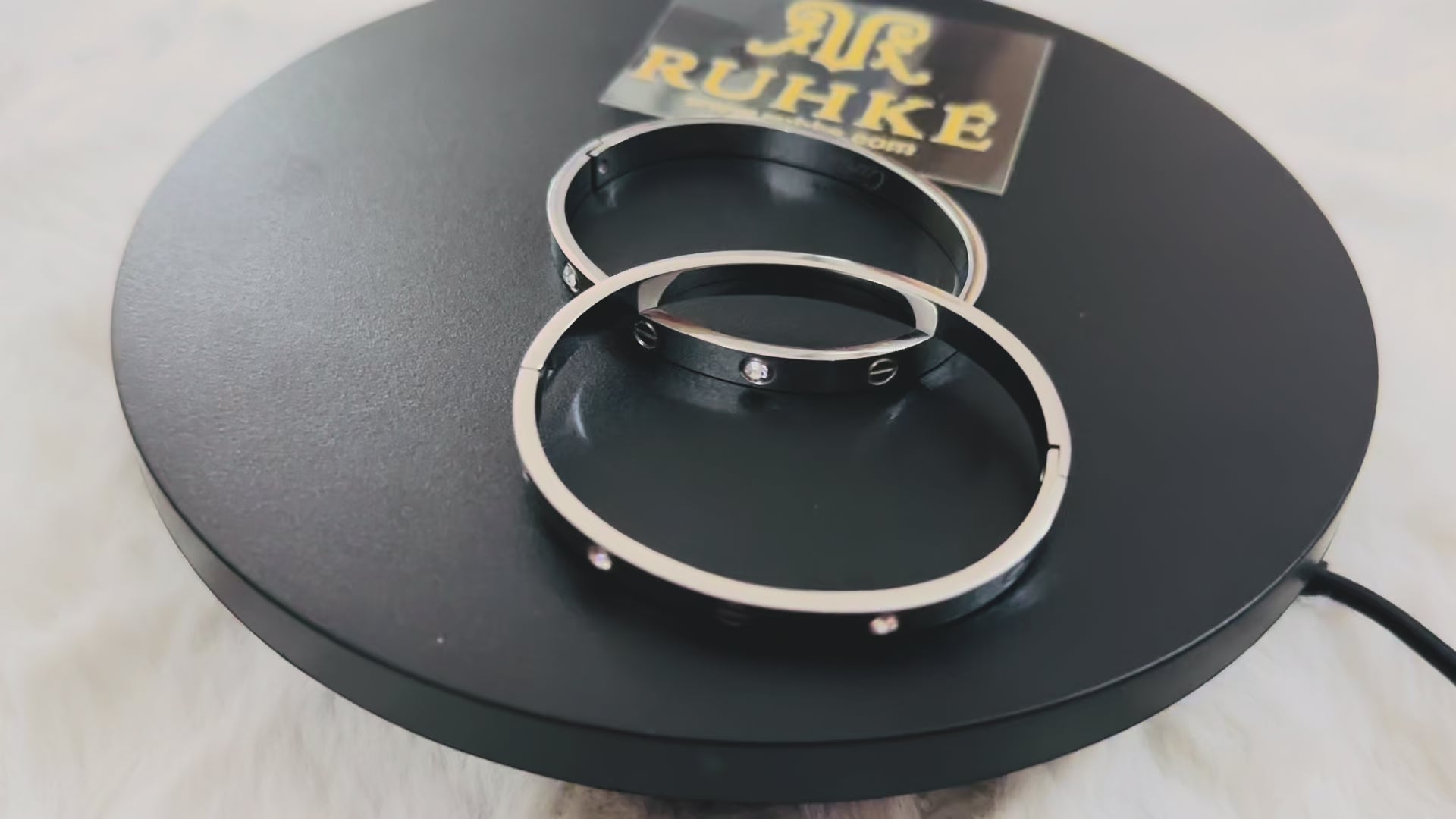 Luxury silver bangle bracelet with alternating crystal stones and linear screw details, captured on video