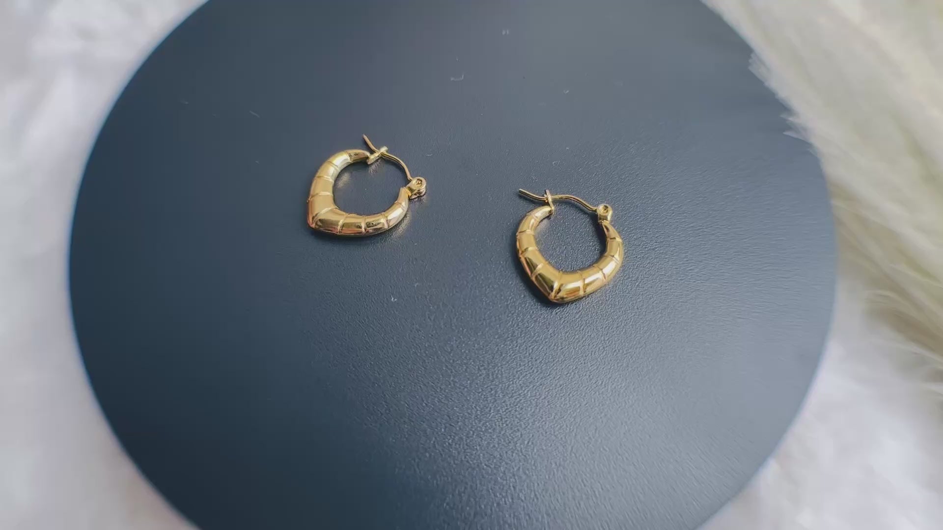 RUHKÉ™ stainless steel hoop earrings on white background 